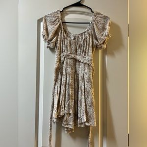 Cute light brown romper with cute designs around it, ties around your waist
